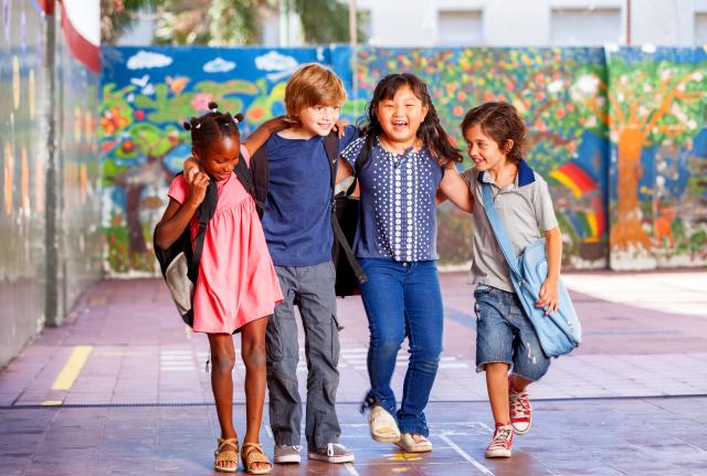 Four students laughing with each other