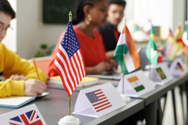 an image of flags in front of children's desks in a model UN setting